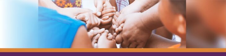 Kids holding hands in a circle.