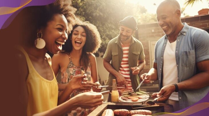 Group of friends grilling outside and smiling together.