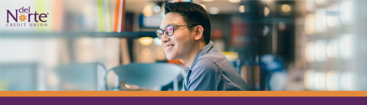 Young male employee working in library.