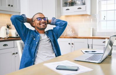 A man relaxes in front of his computer.