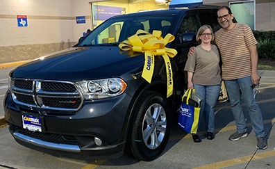 Couple Stands Next To New Truck Purchase