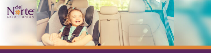 Young toddler happy sitting in car seat