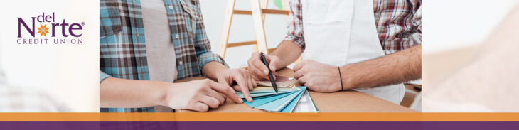 Two people looking at paint samples for home renovations.