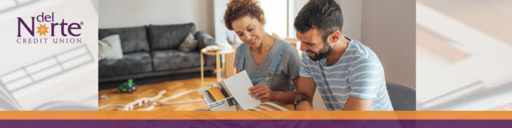 Man and woman looking at home finishes in catalog for home improvement project planning.