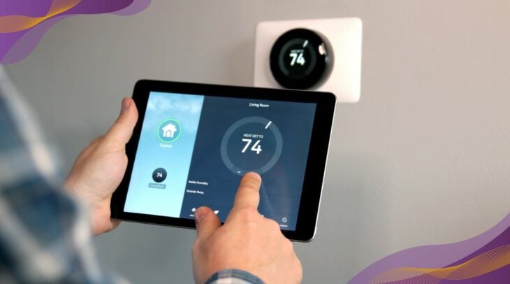 Person adjusting smart thermostat with tablet.