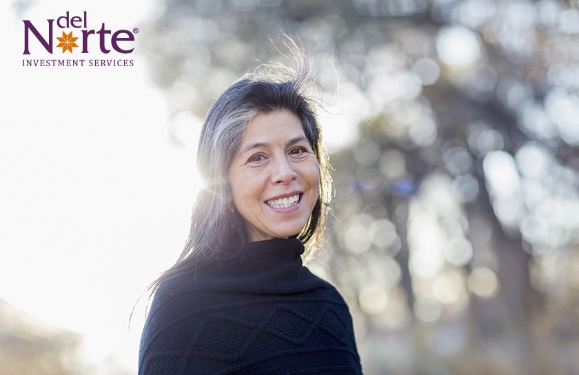 Del Norte Investment Services logo near smiling elderly woman in the park