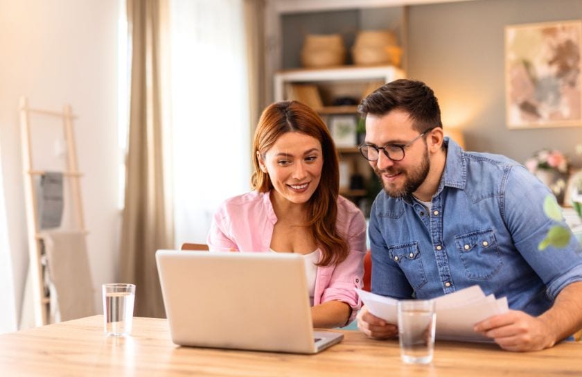 A couple checks their accounts, online.