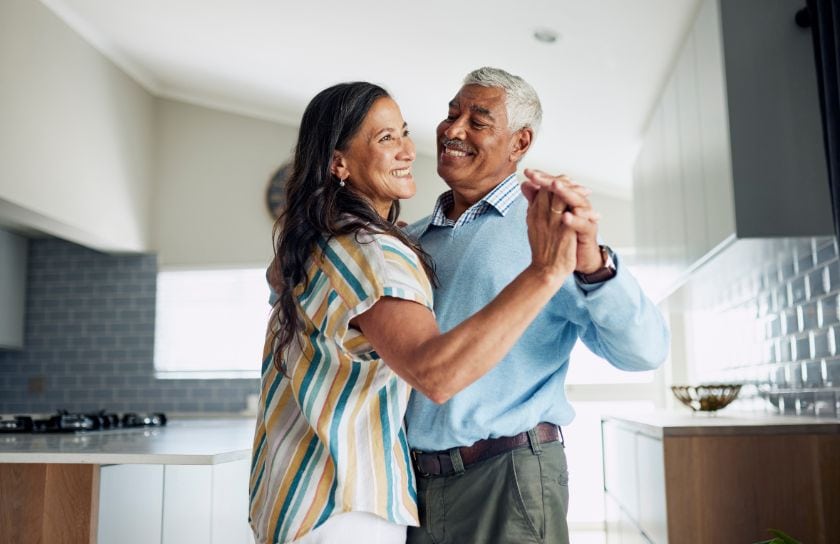 A couple dancing in the kitchen.