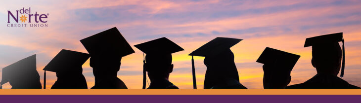 Silhouette of graduate students wearing cap and gown against sunset background.