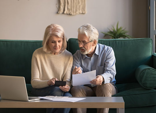 My Investment_ iew Older couple Looking at finances on Laptop