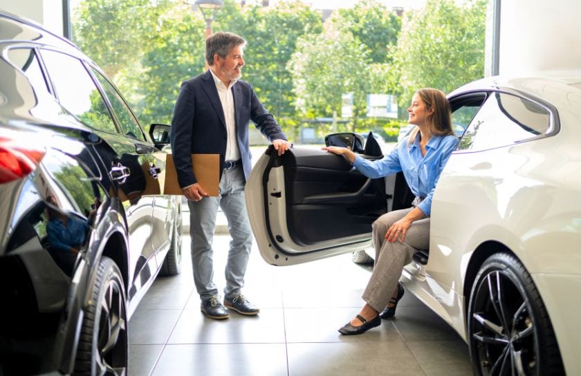 A young woman shops for a new car.