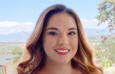 DNCU Member Nikole G smiles with New Mexico landscape in background