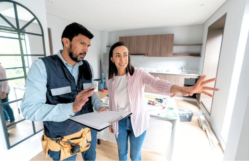 A woman tells a service worker what she is looking to repair.
