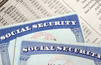 Two social security cards sitting on top of investment document