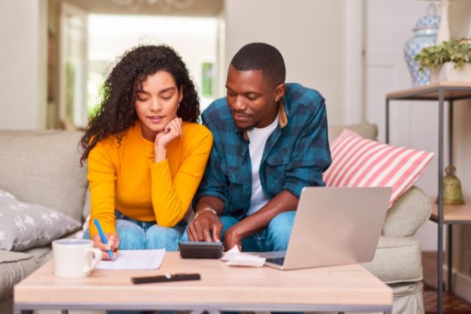 A young couple creates a budget together.