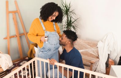 A young mom and dad build a crib in their new home