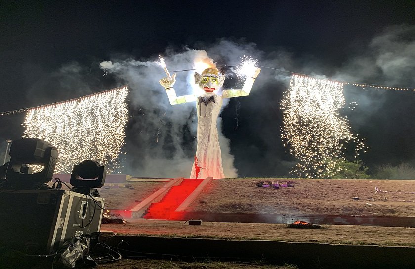Zozobra surrounded by fireworks as tv news camera records