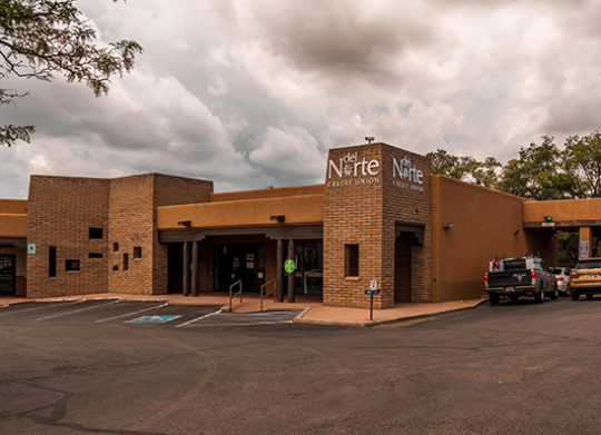 DNCU De Vargas branch exterior with parking spaces