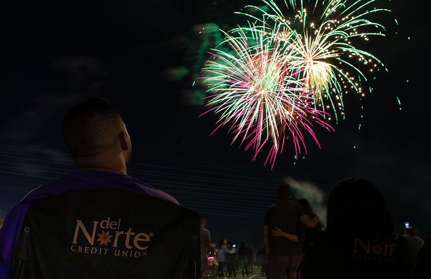 DNCU employee looks up at explosion of fireworks during fourth of july celebration