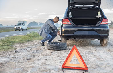 Man changes a flat tire