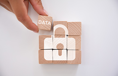 Nine wooden play blocks that spell out the word DATA with image of padlock