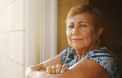 Older Hispanic female looking out her window