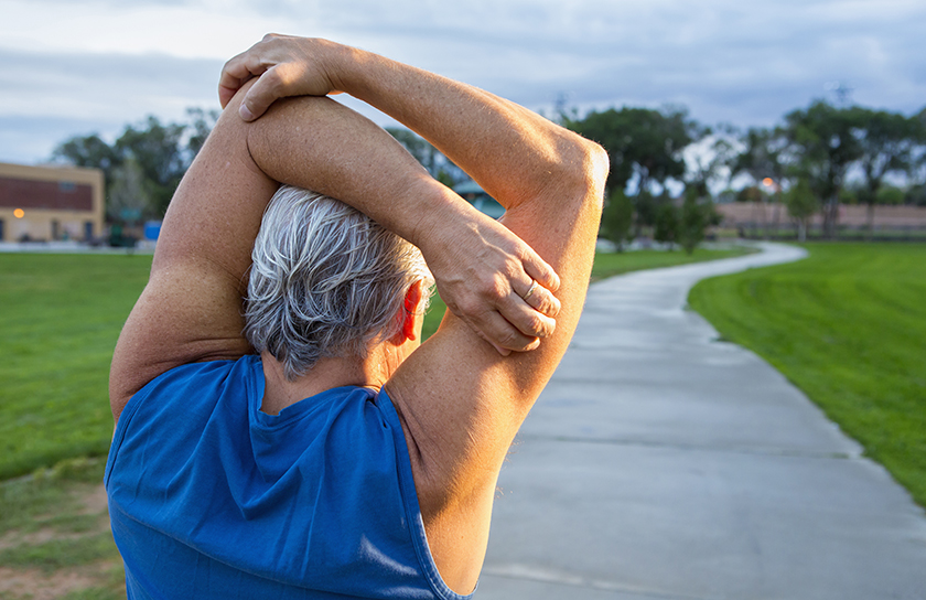 Senior male stretching before a run in the park