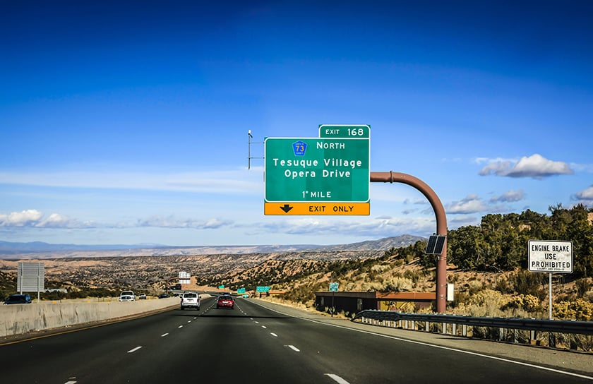 Highway sign between Espanola and Santa Fe in New Mexico