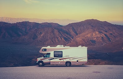 RV parked in empty lot in desert of New Mexico